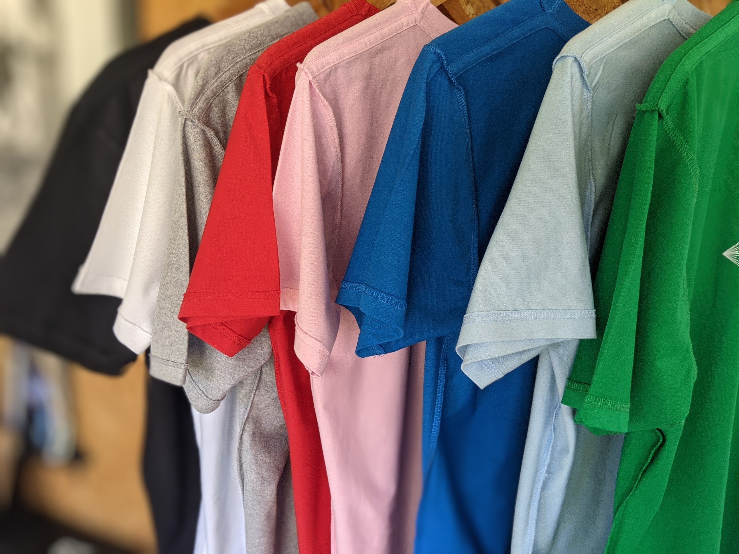 COLOURFUL INSIDE-OUT WEAR T SHIRTS HANGING IN A ROW