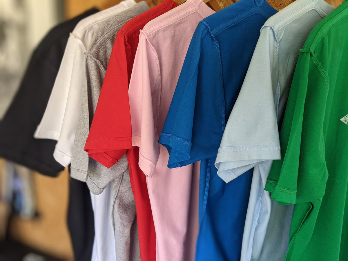 COLOURFUL INSIDE-OUT WEAR  T SHIRTS HANGING IN A ROW
